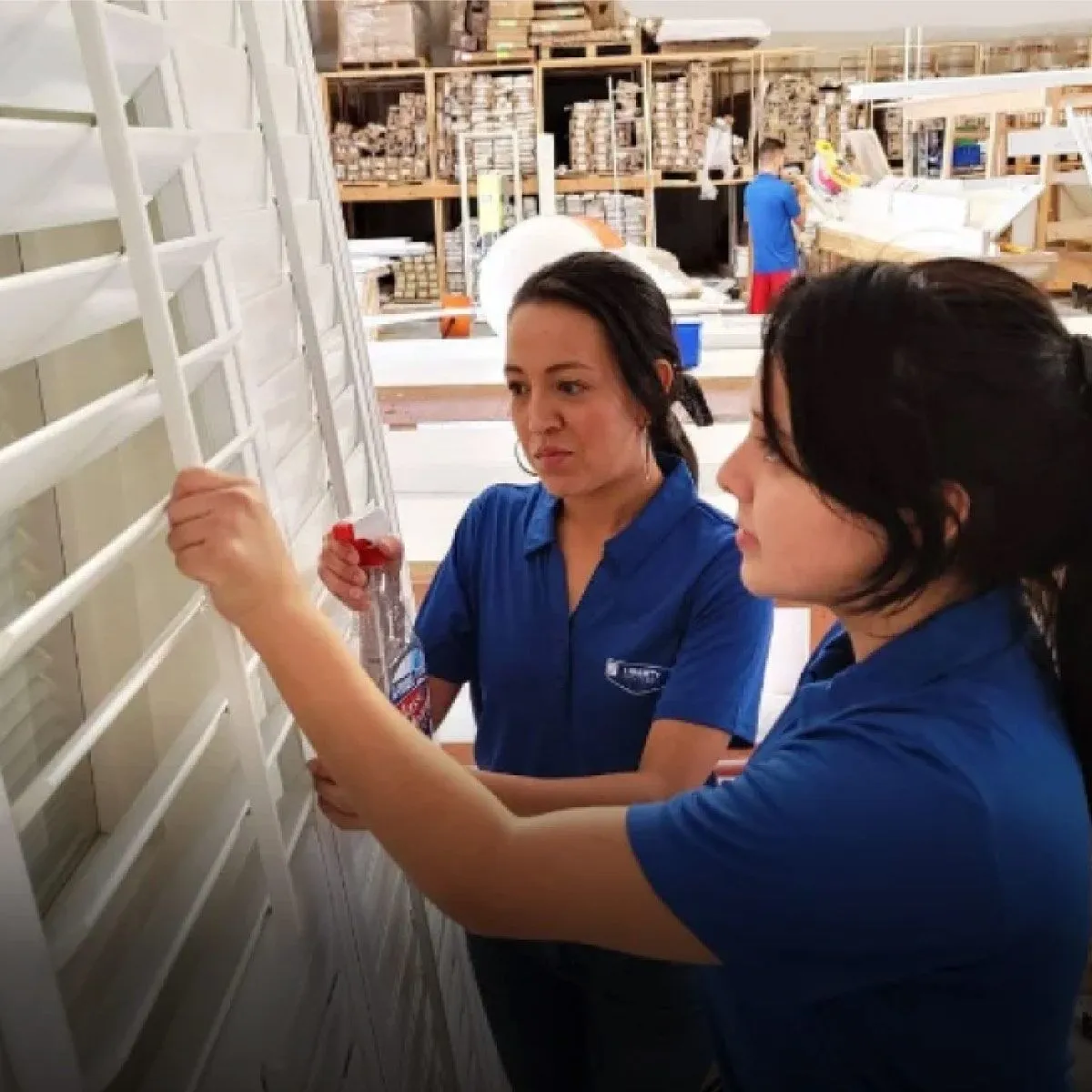Two female workers inside the Liberty Shutter factory
