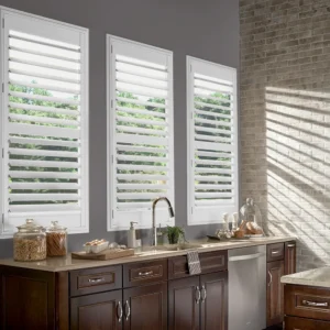 Bright kitchen with white window shutters, wood cabinetry, and natural light.